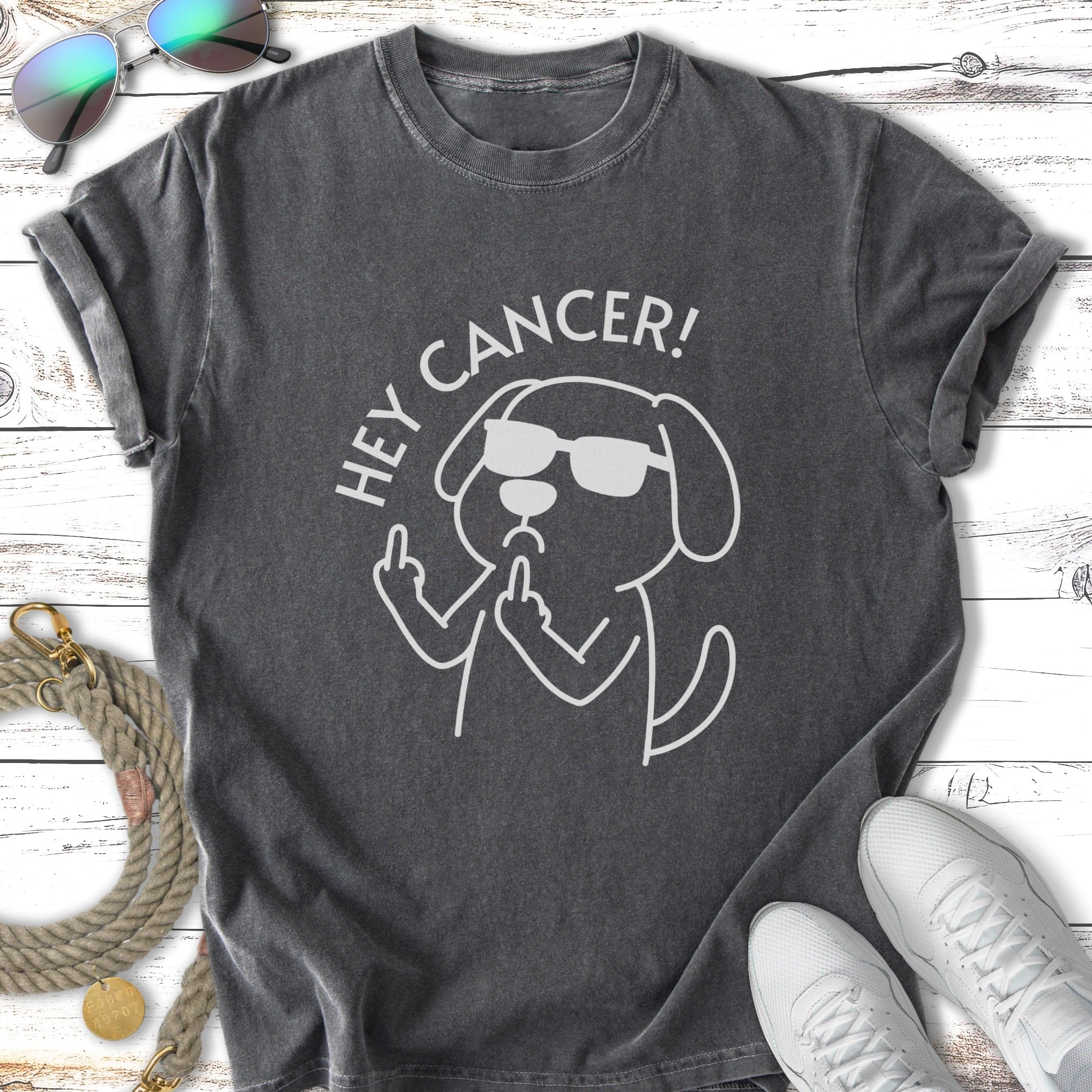 White graphic of a dog wearing sunglasses giving the middle finger with "HEY CANCER!" text.