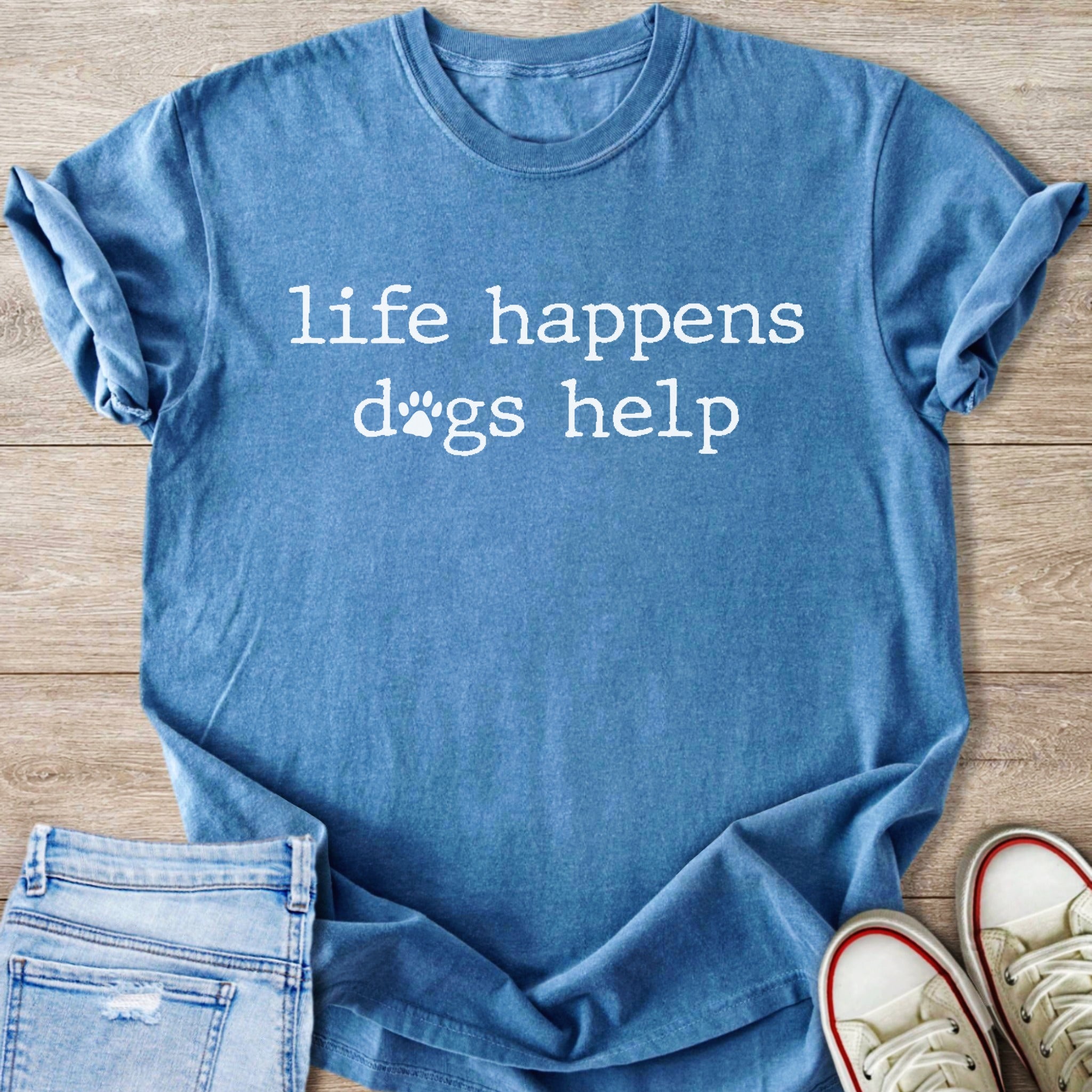 Blue t-shirt with white text "life happens dogs help" and paw prints.