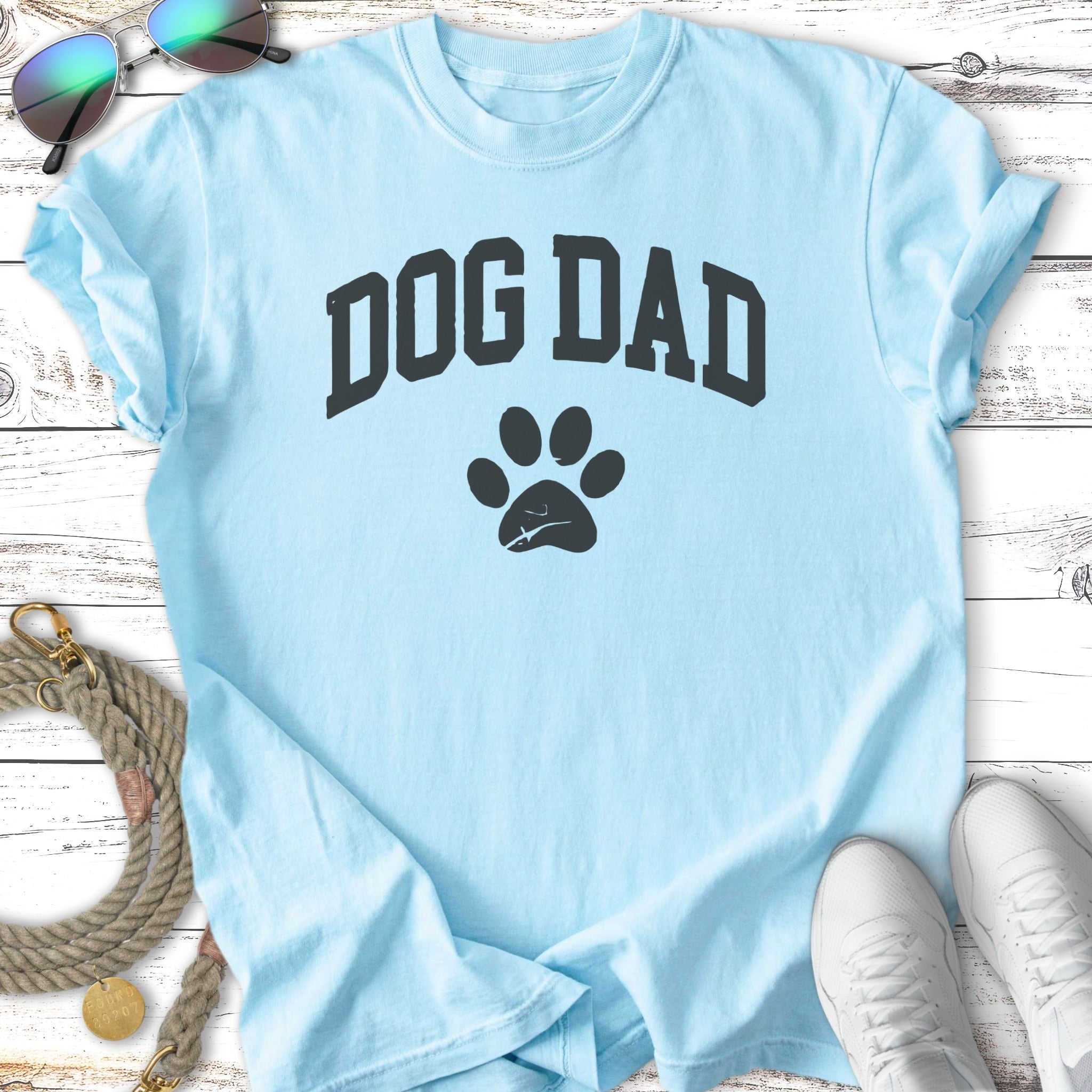 Light blue t-shirt with "DOG DAD" and a paw print graphic.