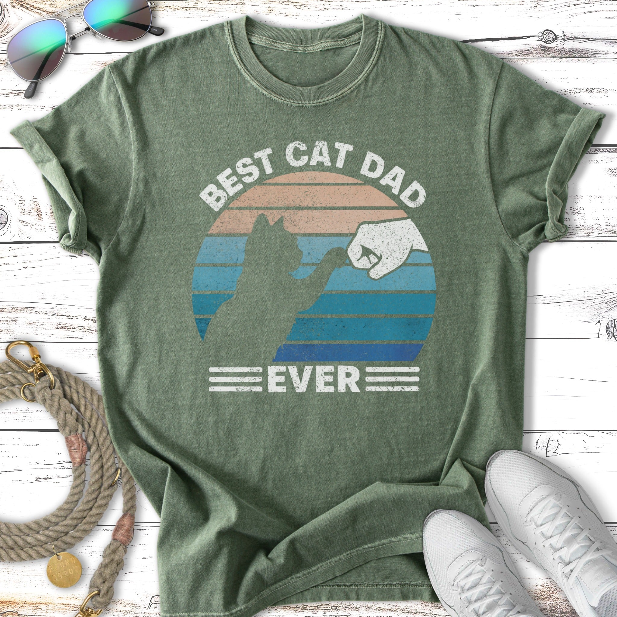 Green t-shirt with "Best Cat Dad Ever" text and silhouette of cat and fist bump.