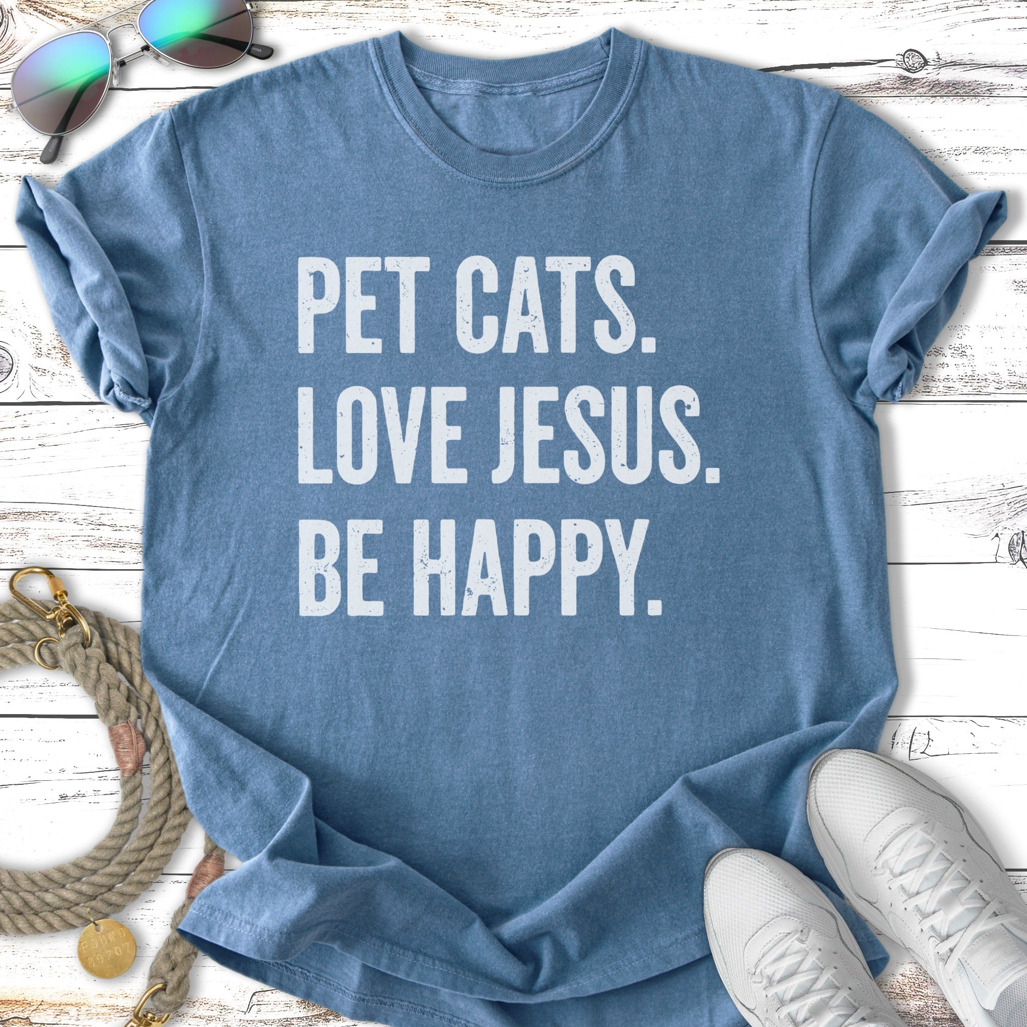 Blue t-shirt with "PET CATS. LOVE JESUS. BE HAPPY." text.