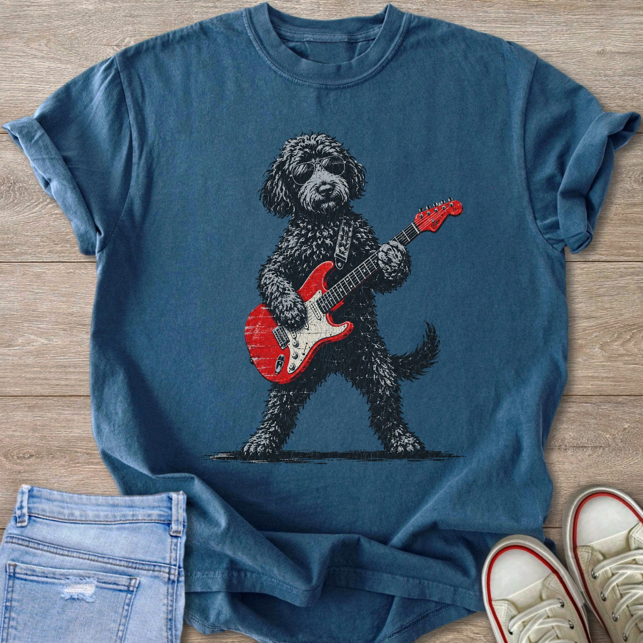 T-shirt with a black dog wearing sunglasses and playing a red electric guitar.
