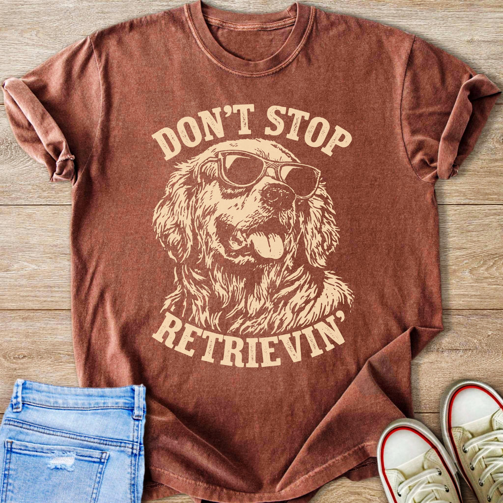 Brown t-shirt with "Don't Stop Retrieving" text and sunglasses-wearing dog graphic.