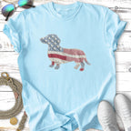 Light blue t-shirt with a patchwork dachshund made of American flag and plaid fabric.