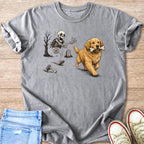 Golden retriever carrying a bone chases a skeleton in a graveyard.