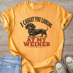 Yellow t-shirt with dachshund wearing sunglasses and text "I CAUGHT YOU LOOKING AT MY WEINER".
