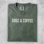 Green Comfort Colors t-shirt with "DOGS & COFFEE" printed in white.
