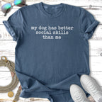 Blue t-shirt with "my dog has better social skills than me" text.