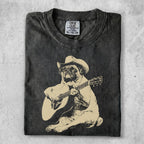 T-shirt with a beige pug wearing a cowboy hat playing a guitar.