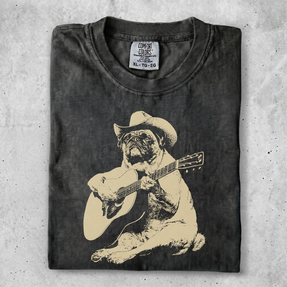T-shirt with a beige pug wearing a cowboy hat playing a guitar.