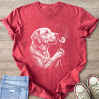 Red t-shirt graphic with white line drawing of dog holding dandelion.