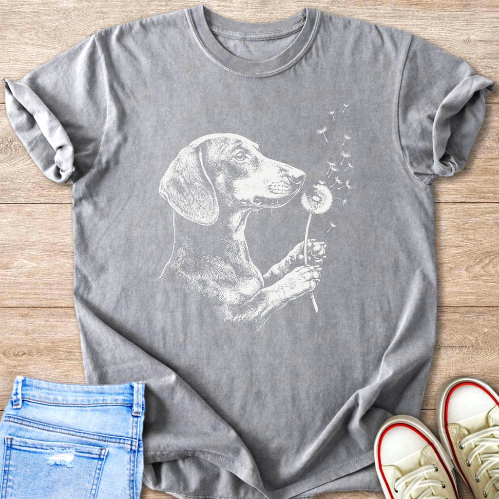 Dachshund dog graphic on grey t-shirt blowing on dandelions