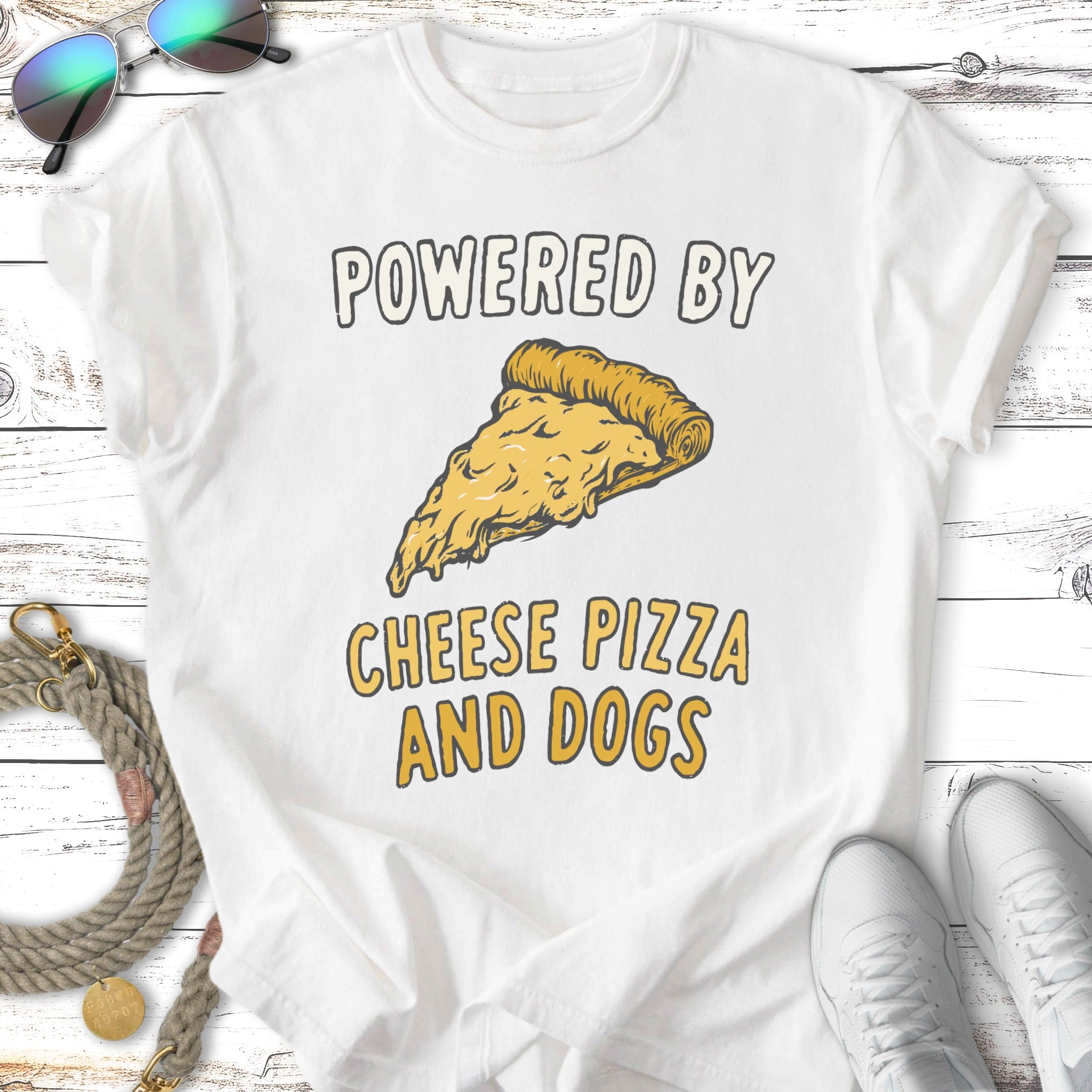 White t-shirt with "Powered by Cheese Pizza and Dogs" text and pizza graphic.