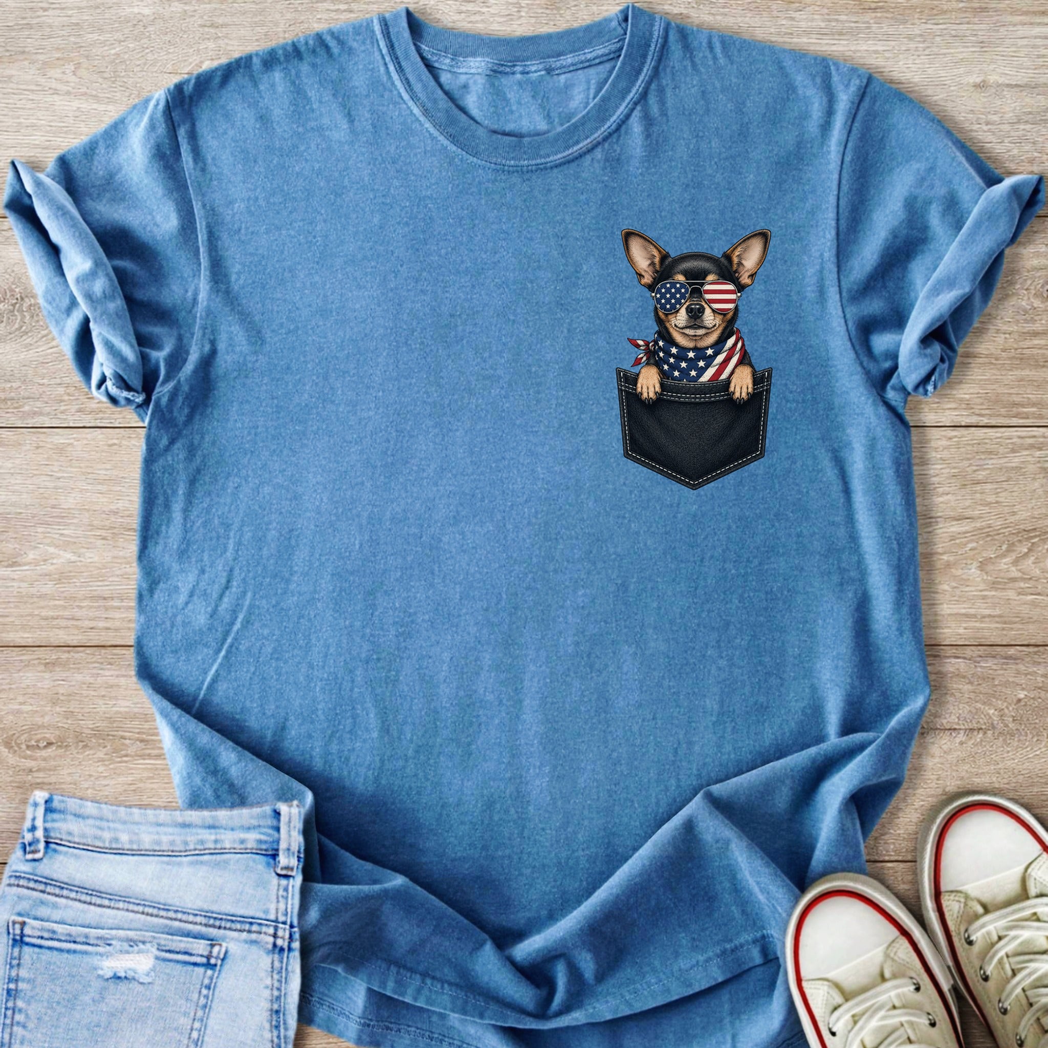 Blue t-shirt with a chihuahua wearing American flag sunglasses and bandana in a faux pocket.