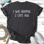 Dark gray t-shirt with white text "I WAS NORMAL 2 CATS AGO".