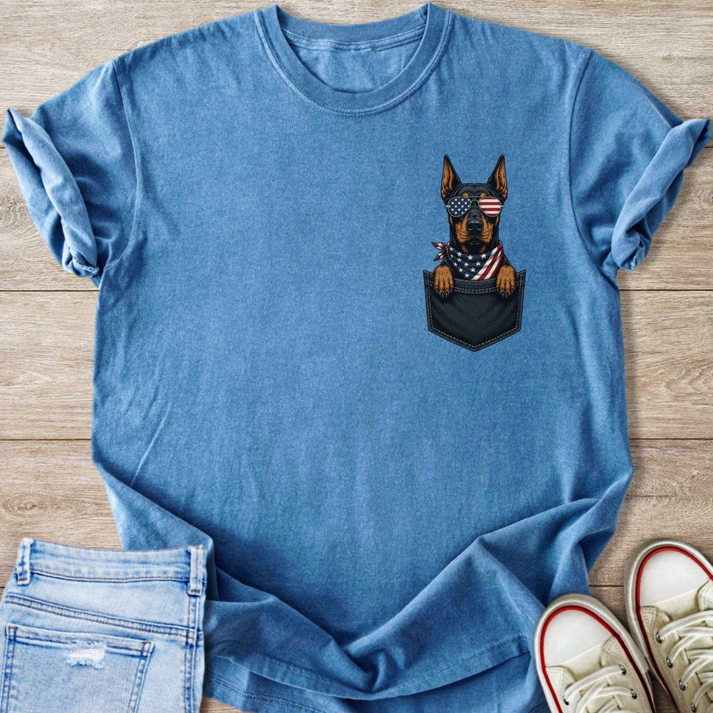 Blue t-shirt with a dog in a pocket wearing American flag sunglasses and bandana.
