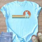 Light blue t-shirt with a retro sunset and French bulldog silhouette graphic.