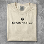 Cream t-shirt with black "treat dealer" text and paw print.