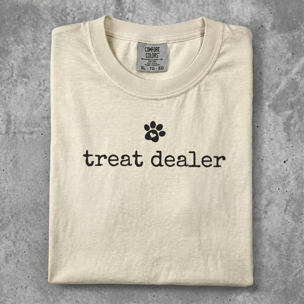 Cream t-shirt with black "treat dealer" text and paw print.