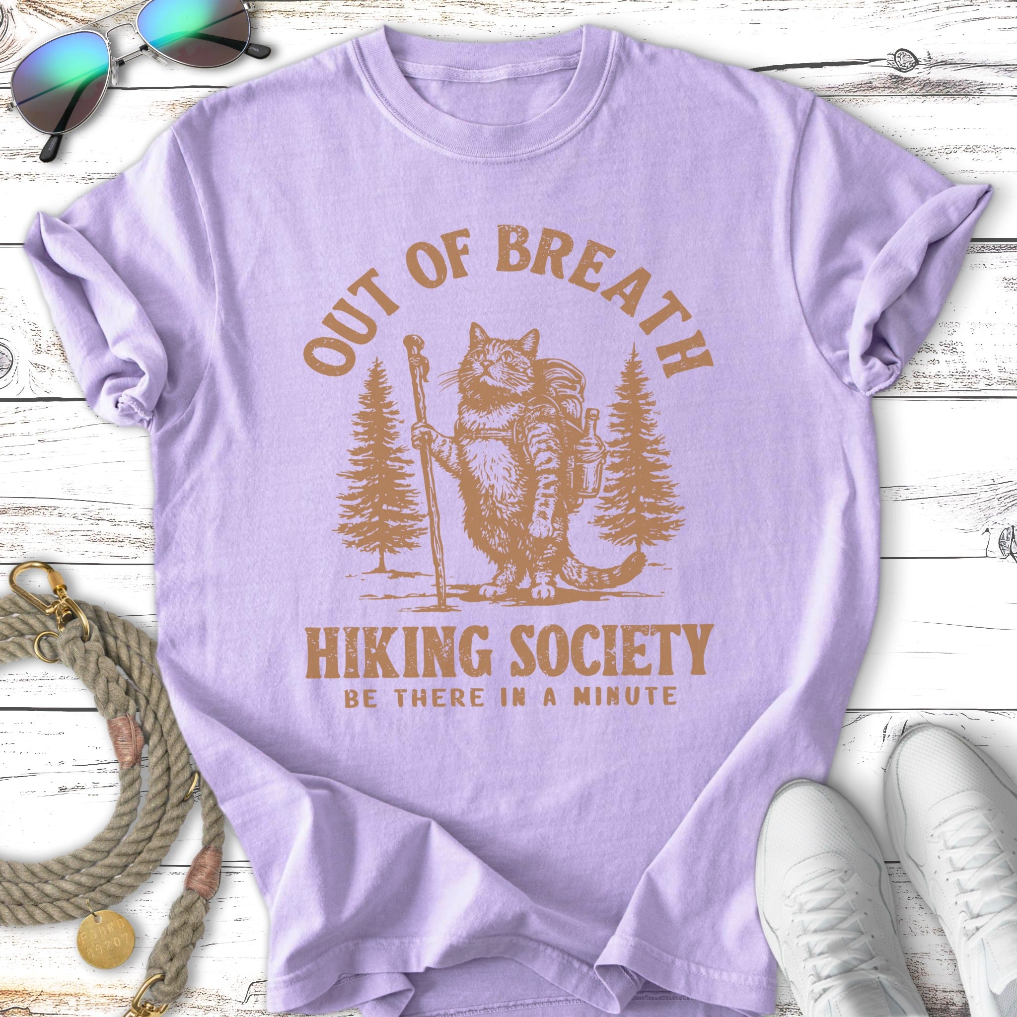 Cat hiker with backpack and walking stick in forest with "Out of Breath Hiking Society" text.