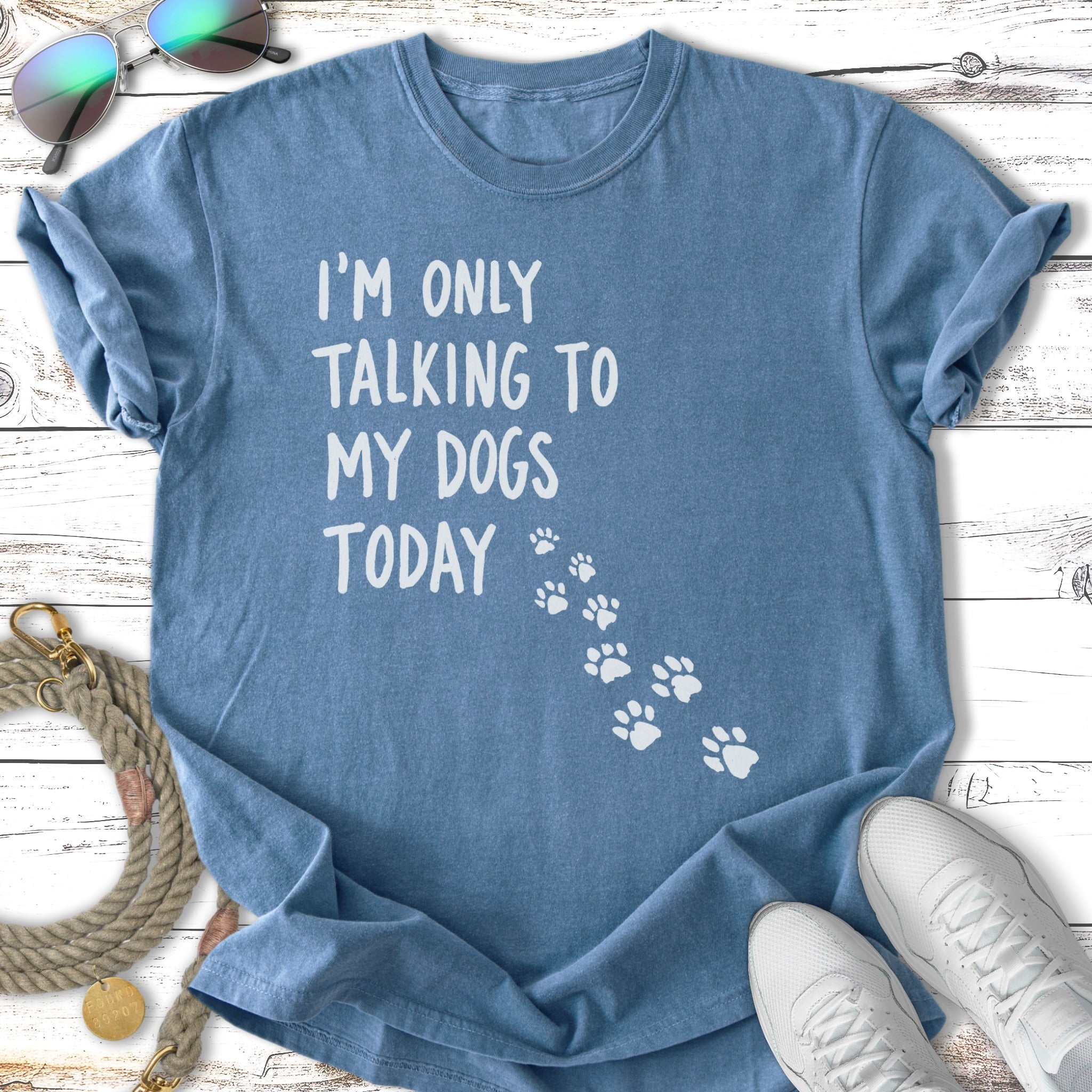Blue t-shirt with "I'm only talking to my dogs today" text and paw prints.