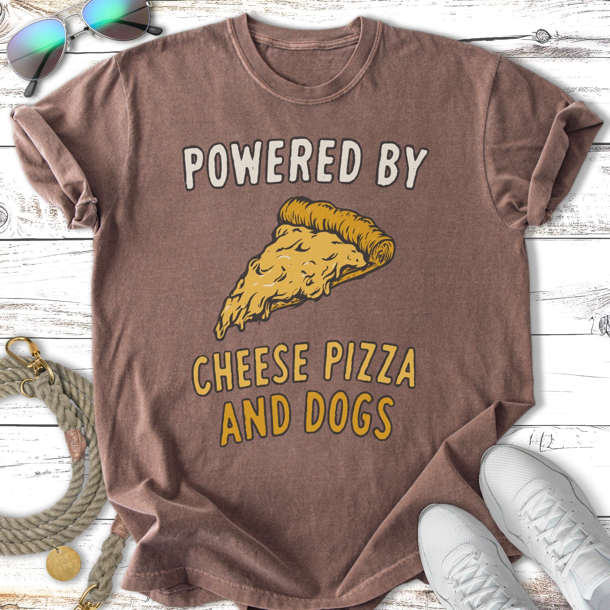 Brown t-shirt with "Powered by Cheese Pizza and Dogs" and pizza slice graphic.