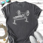 Cat bench pressing weights, vintage distressed graphic on a t-shirt.