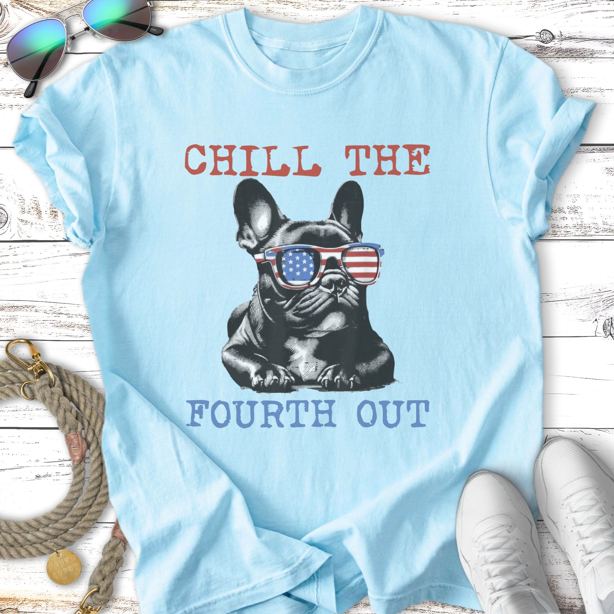 French bulldog wearing sunglasses with American flag pattern, text "CHILL THE FOURTH OUT".
