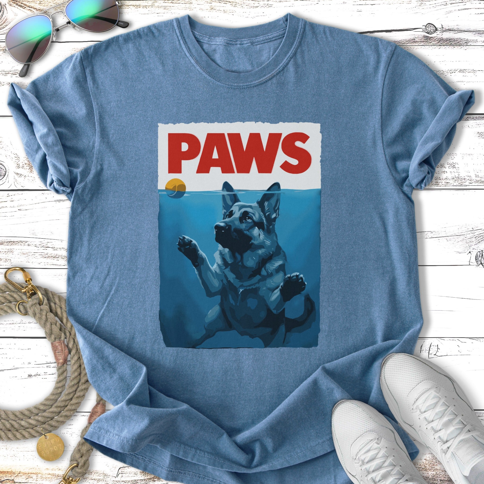 German Shepherd dog swimming underwater reaching for a ball on a t-shirt.