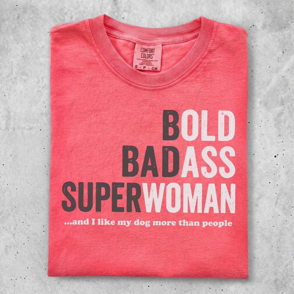 Coral t-shirt with "BOLD BADASS SUPERWOMAN ...and I like my dog more than people" text.