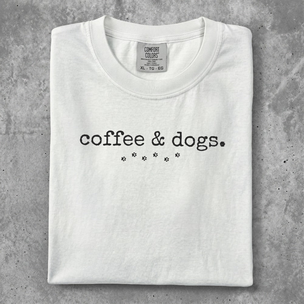 Comfort Colors white t-shirt with "coffee & dogs." text and paw prints.