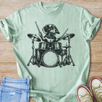 Dachshund playing drums in black ink graphic on a light green t-shirt.