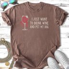 T-shirt with text "I JUST WANT TO DRINK WINE AND PET MY DOG" and wine glass graphic.
