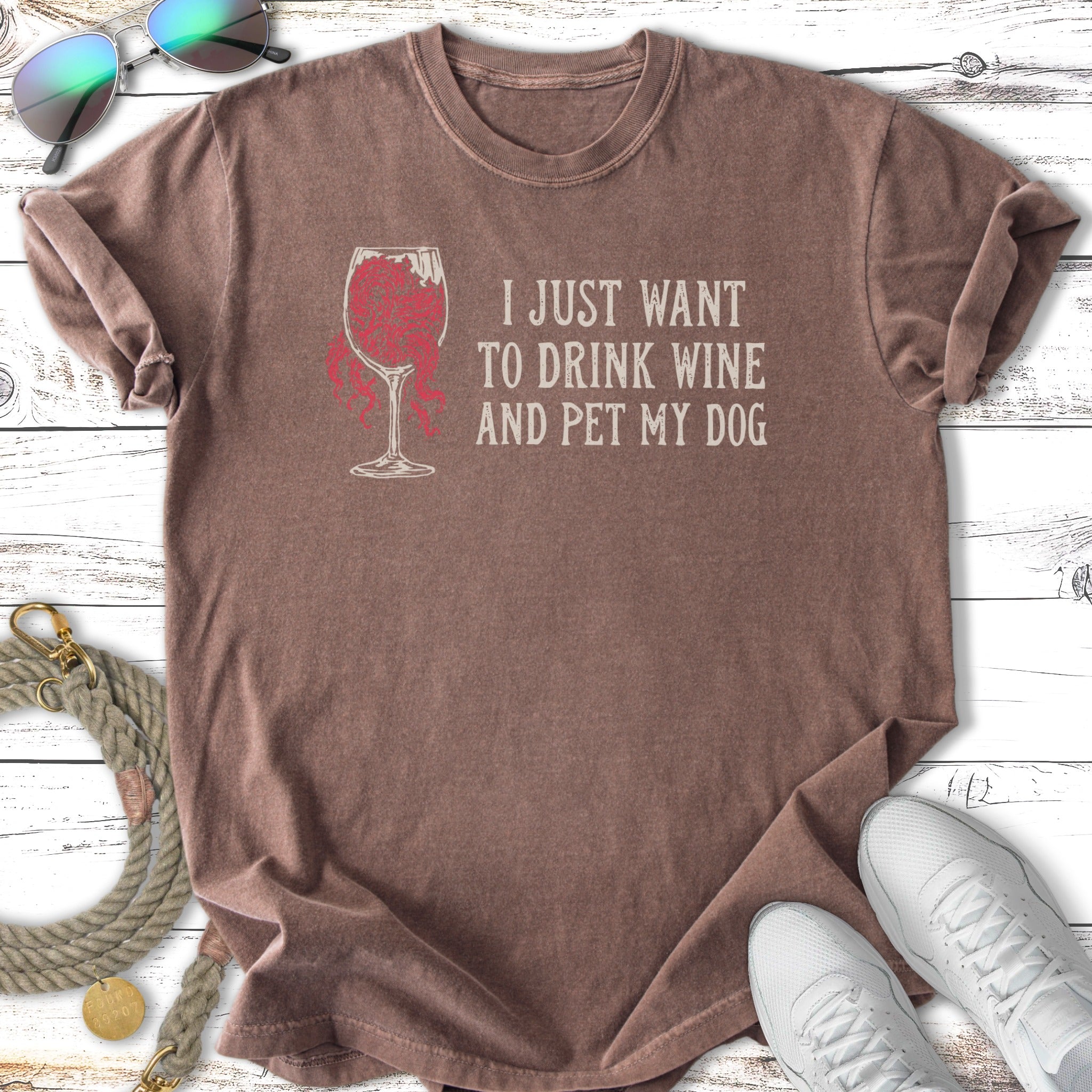 T-shirt with text "I JUST WANT TO DRINK WINE AND PET MY DOG" and wine glass graphic.