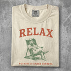 T-shirt with "RELAX NOTHING IS UNDER CONTROL" and dog in lounge chair graphic.