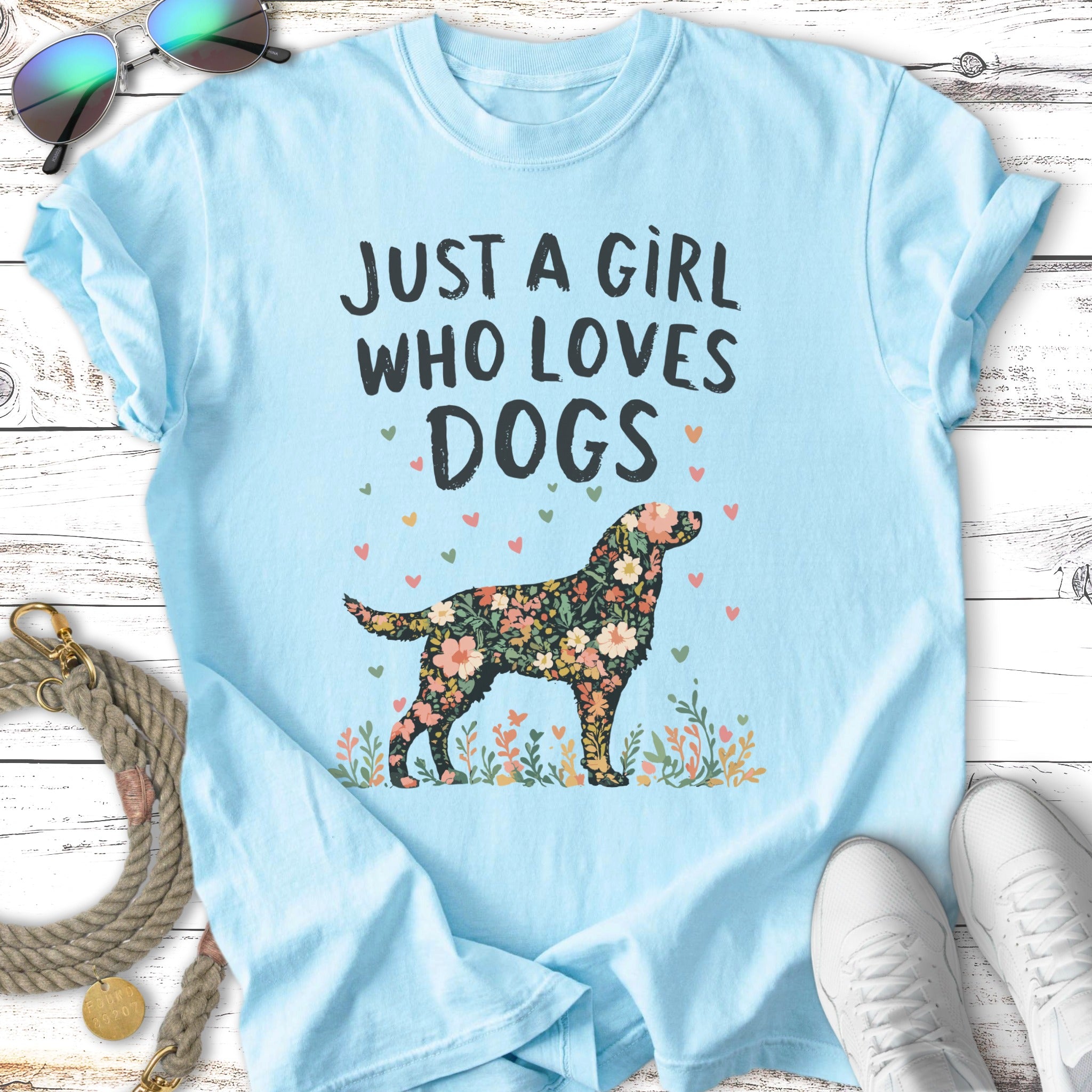 Light blue t-shirt with a floral dog silhouette and text.