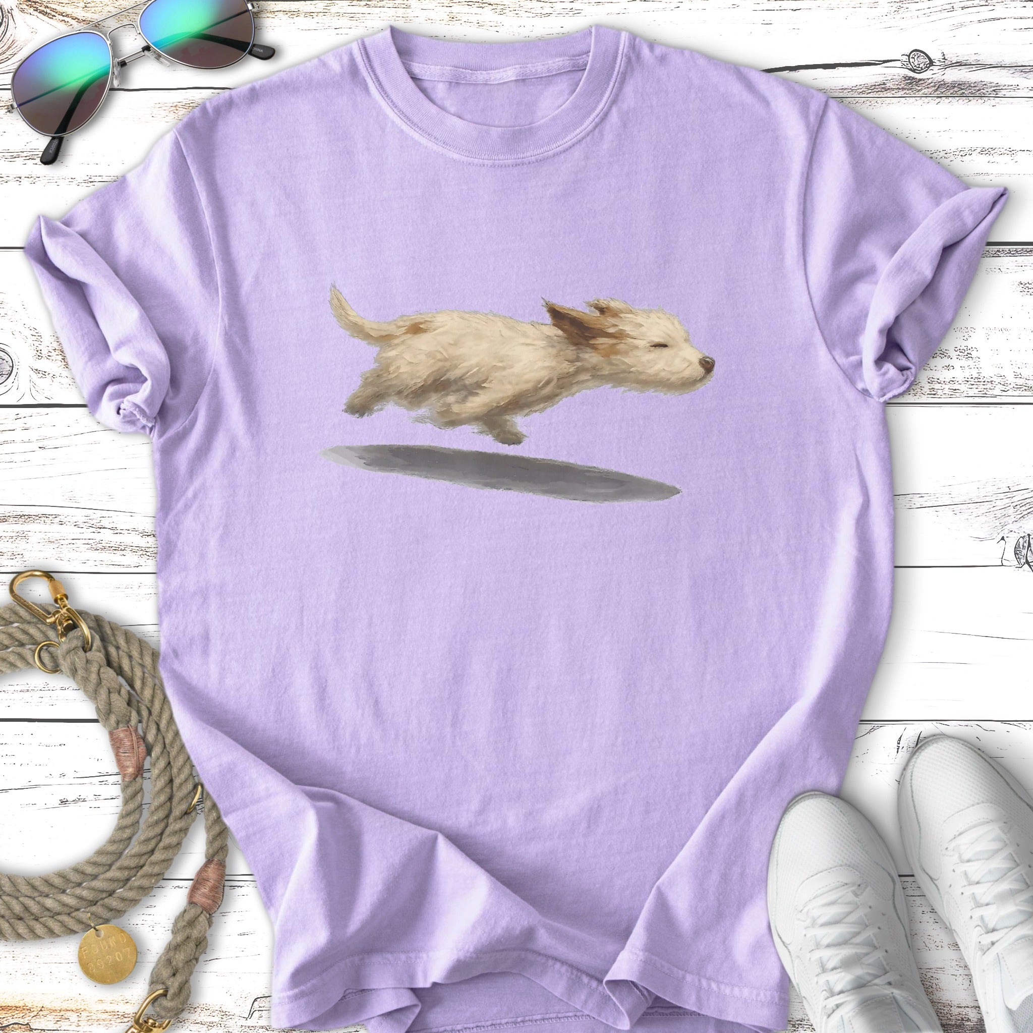 Light purple t-shirt with a fluffy dog mid-run illustration.