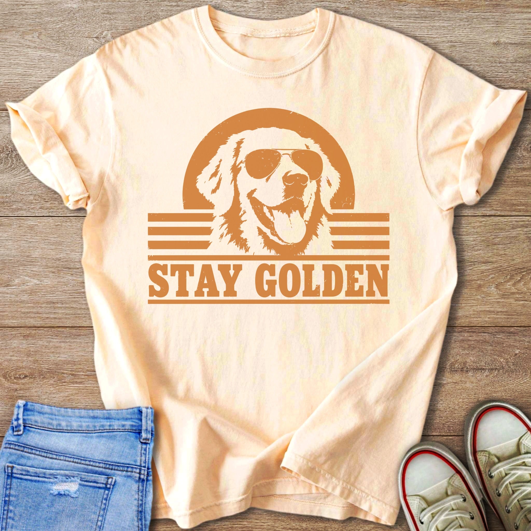 Peach t-shirt with distressed graphic of a golden retriever wearing sunglasses and the text "STAY GOLDEN".
