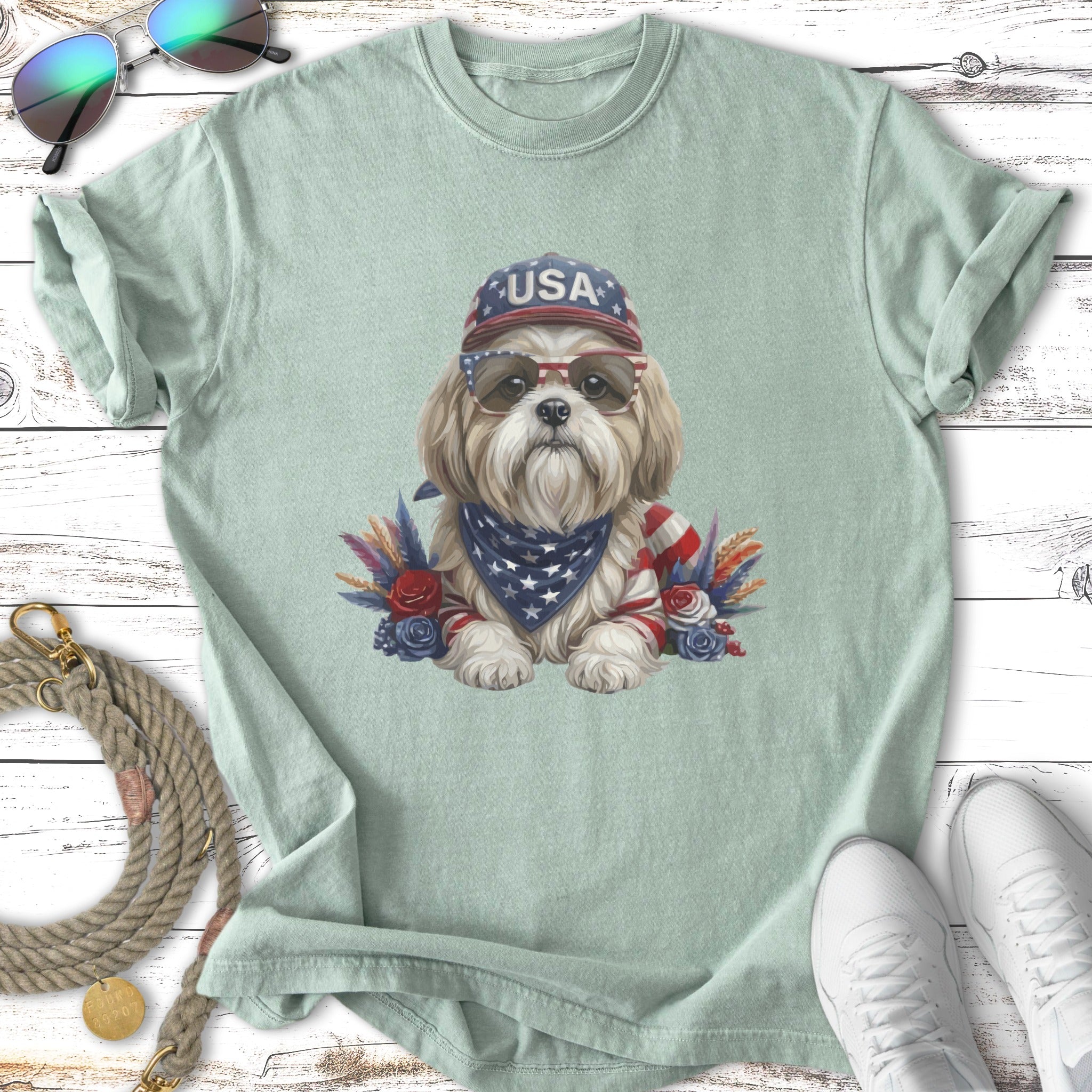 Shih Tzu wearing USA hat and bandana with sunglasses, embellished with feathers.