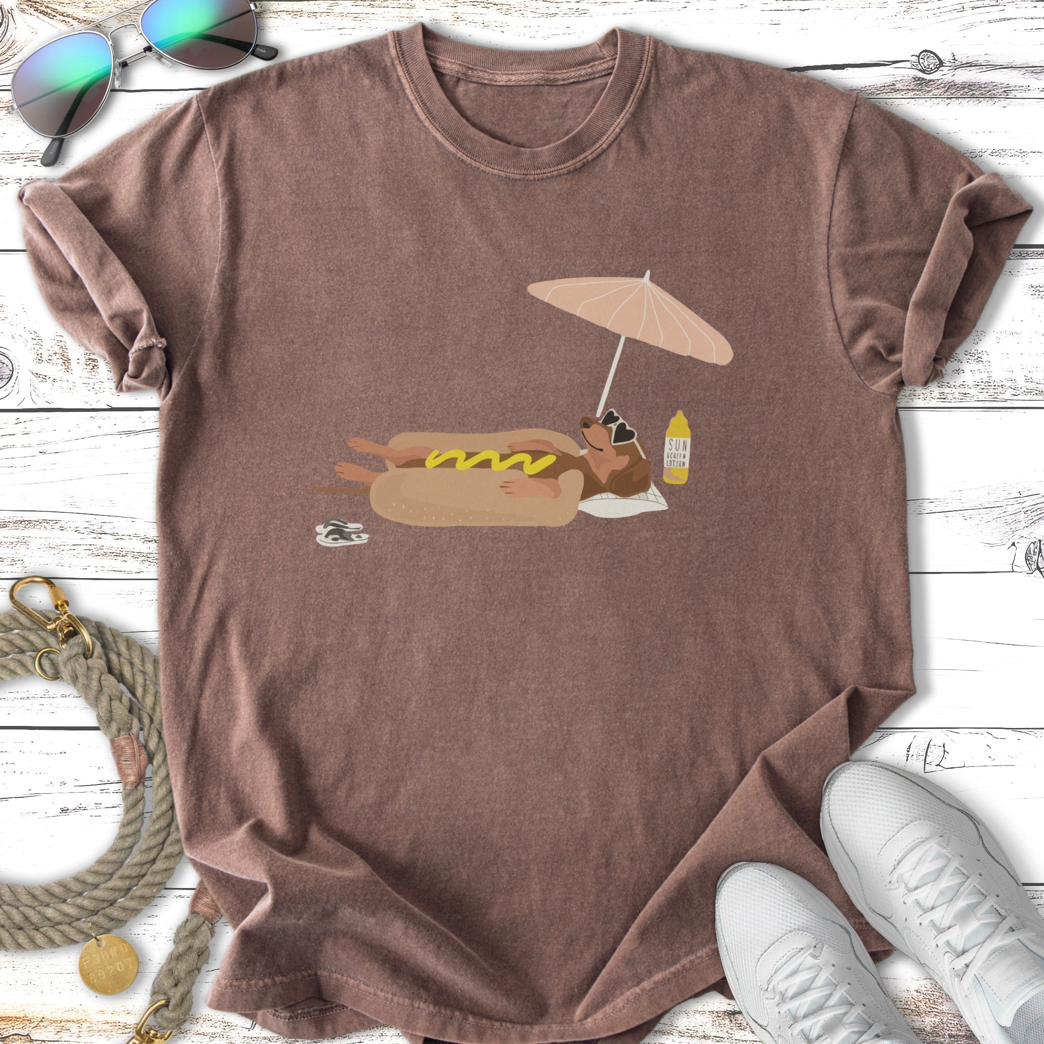 T-shirt featuring a dachshund floating on a hot dog with a sun umbrella.