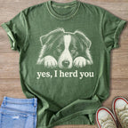 Green t-shirt with white line art of a Border Collie's face and the text "yes, I herd you".