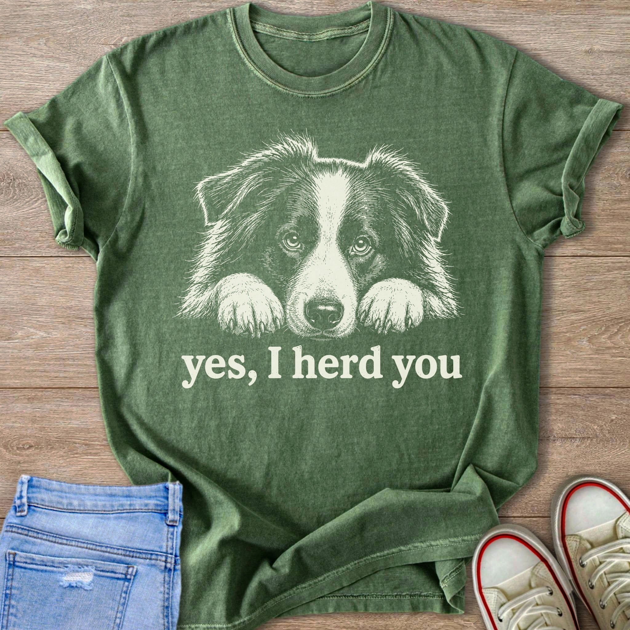 Green t-shirt with white line art of a Border Collie's face and the text "yes, I herd you".