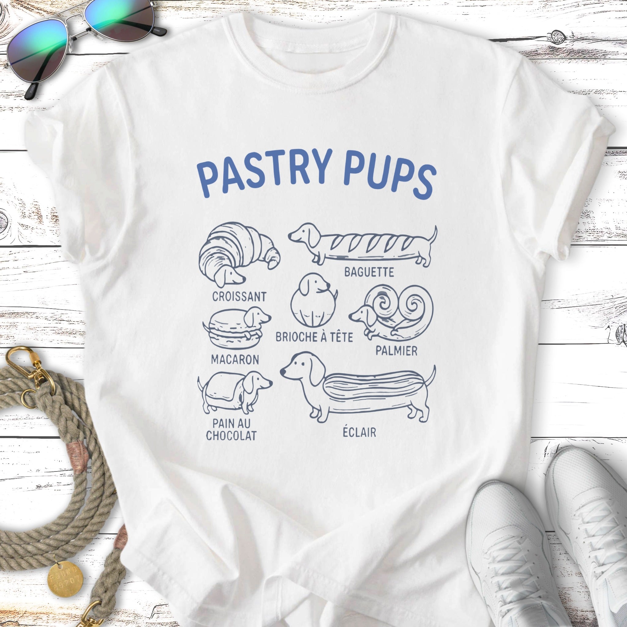 White t-shirt with "Pastry Pups" and illustrations of dog breeds as pastries.