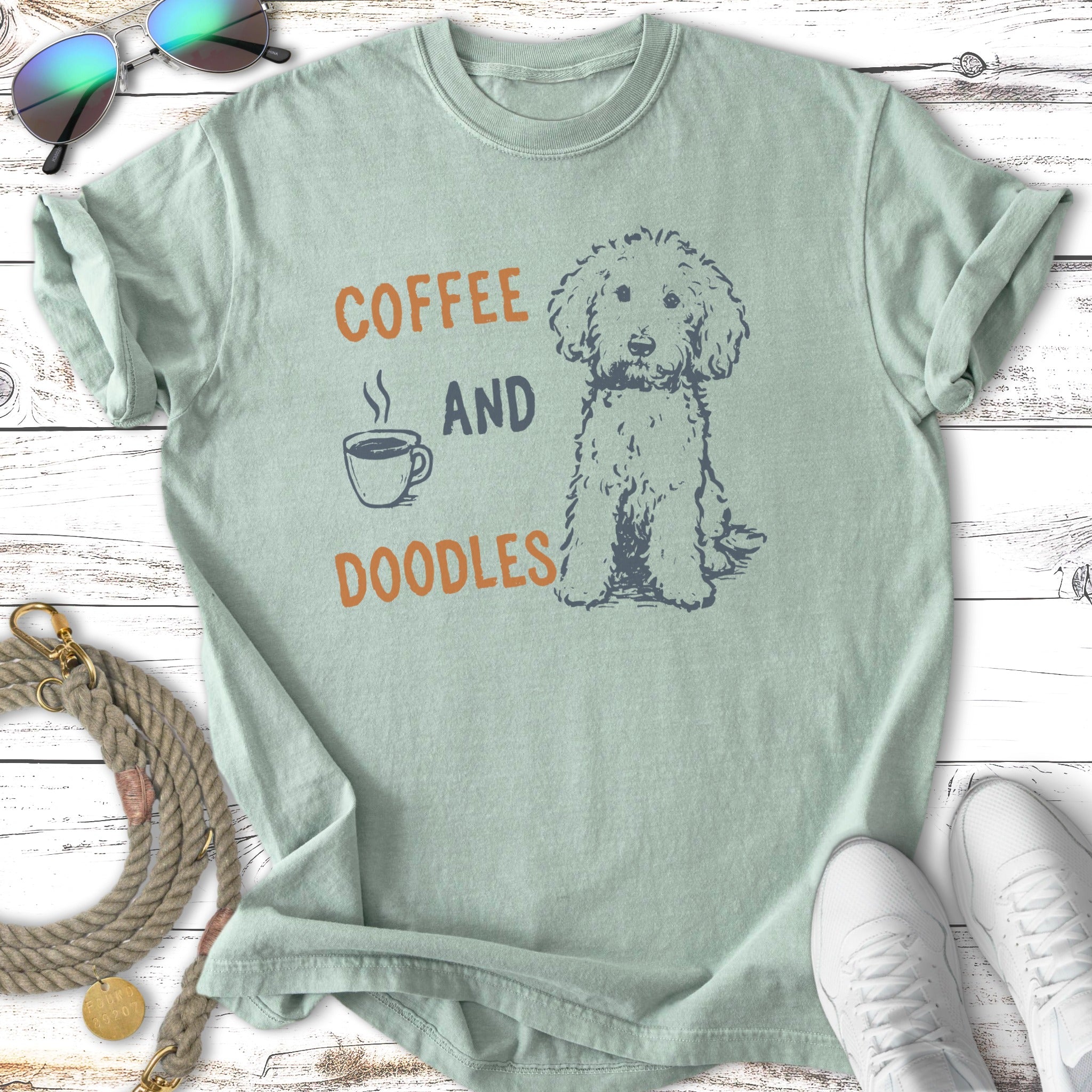 T-shirt with "Coffee and Doodles" text and a sitting doodle dog illustration.