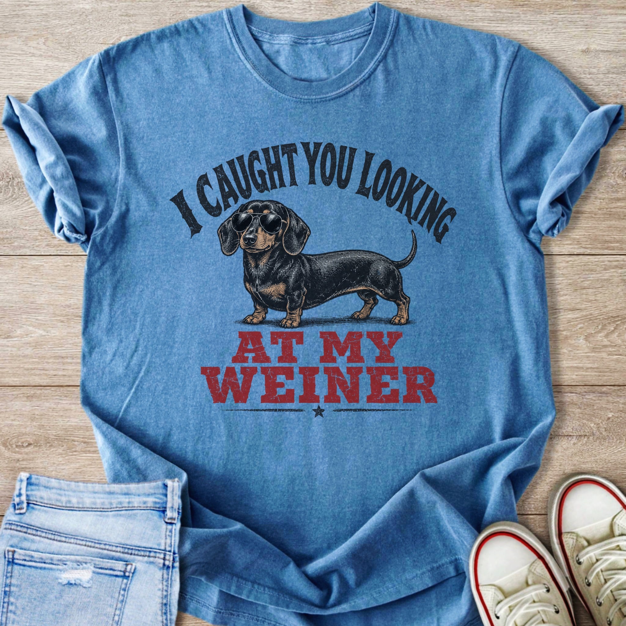 Blue t-shirt with dachshund wearing sunglasses and text "I CAUGHT YOU LOOKING AT MY WEINER".