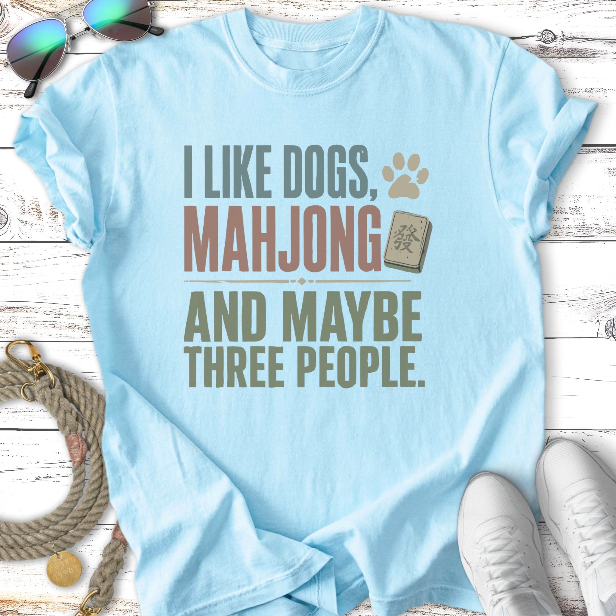 Light blue t-shirt with "I like dogs, mahjong and maybe three people" text.