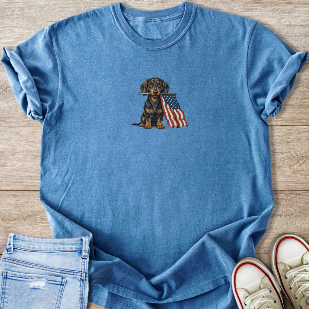Blue t-shirt with embroidered dachshund holding American flag.
