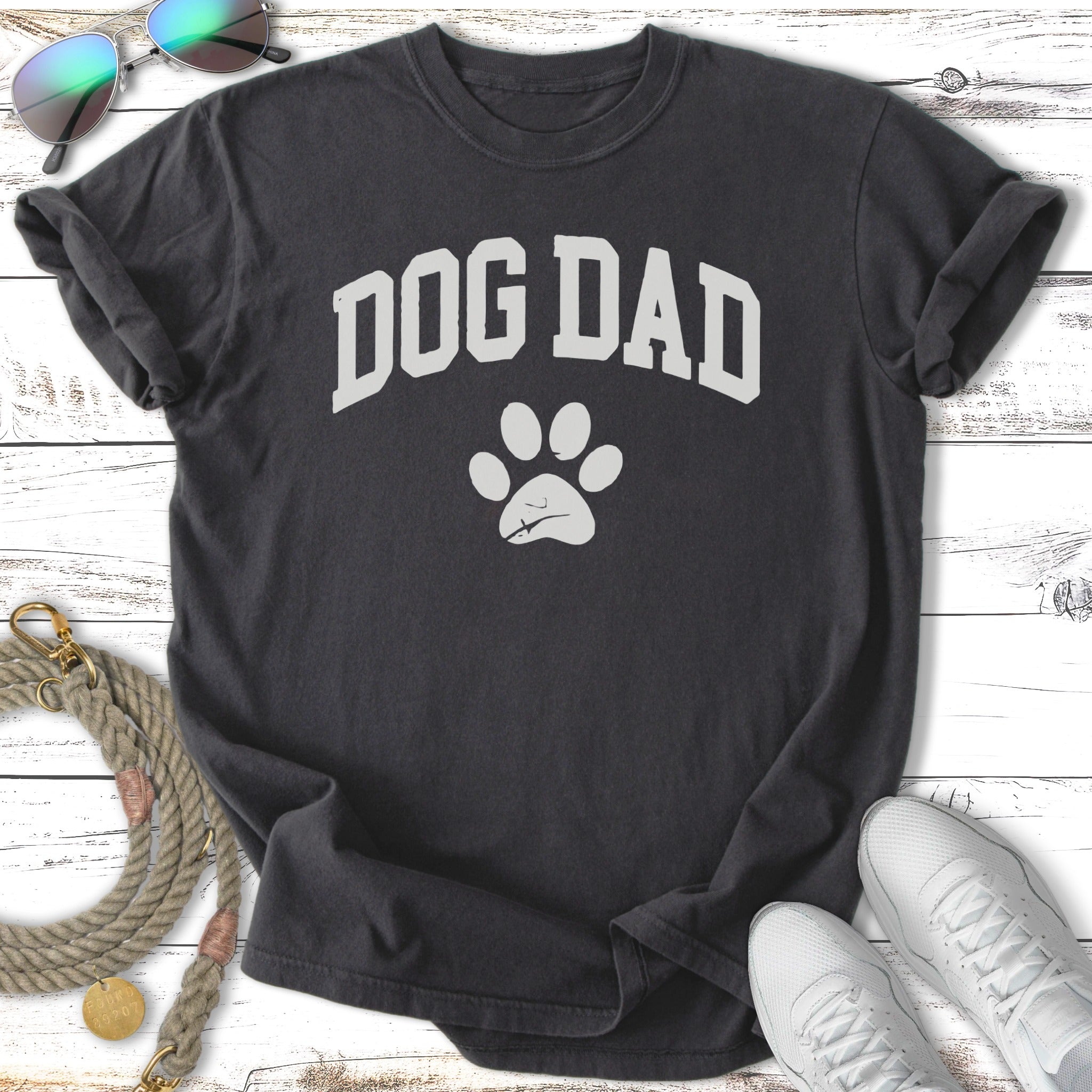 Dark t-shirt with "DOG DAD" text and a paw print graphic.
