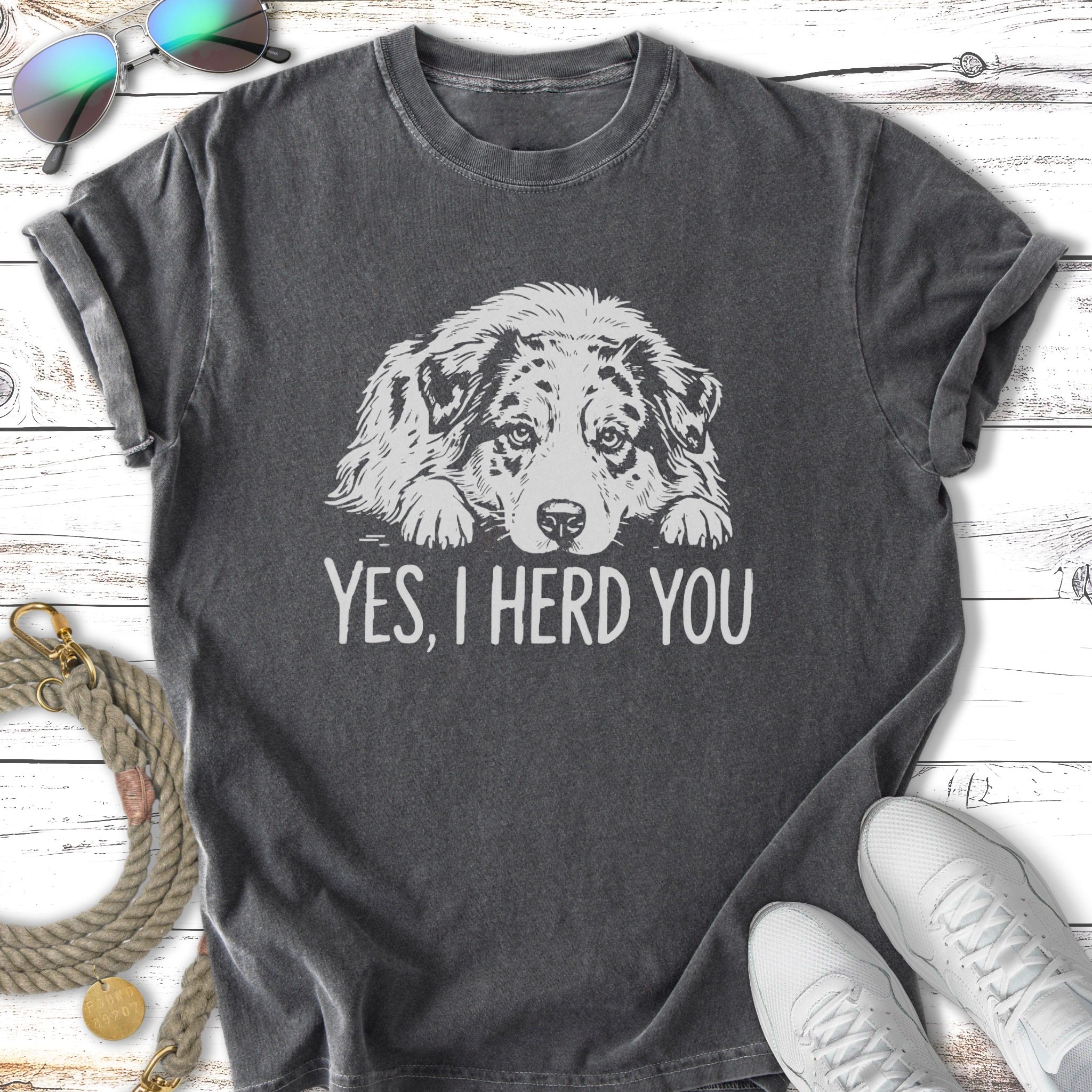 Dark t-shirt with "Yes, I Herd You" and an Australian Shepherd dog illustration.