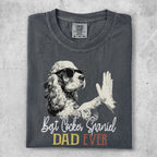 Cocker Spaniel wearing sunglasses gives a high-five on a charcoal t-shirt.